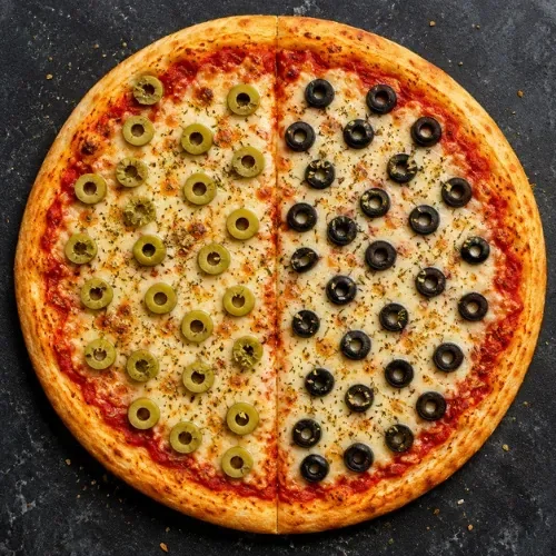 A pizza divided into two halves, one topped with green olives and the other with black olives.